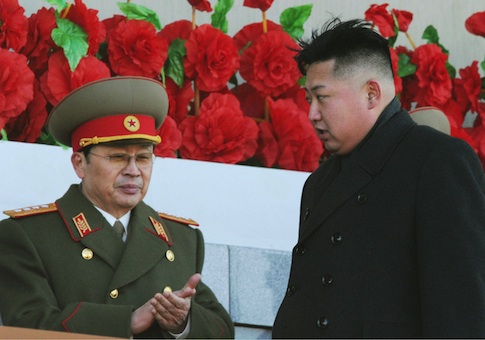 Jang Song Thaek (L), uncle of North Korean leader Kim Jong Un (R) and then vice chairman of the National Defense Commission, after viewing a military parade during a ceremony to mark the 70th anniversary of the birth of the late leader and Kim's father Kim Jong Il in Pyongyang on Feb. 16, 2012