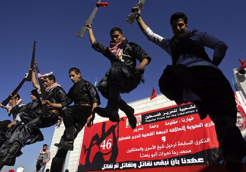 Palestinians dance at a rally marking the 46th anniversary of the founding of the Popular Front for the Liberation of Palestine