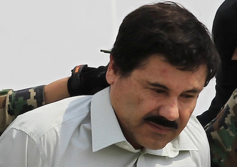 Joaquin "Shorty" Guzman is being escorted by soldiers during a presentation at the Navy's airstrip in Mexico City