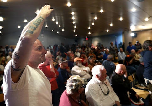 Veteran Mark Howey waits to ask a question as Sen. John McCain speaks during a forum with veterans regarding lapses in care