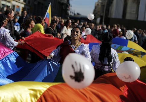 Protestors throw balloons and wave multicolour flags to protest against Chevron