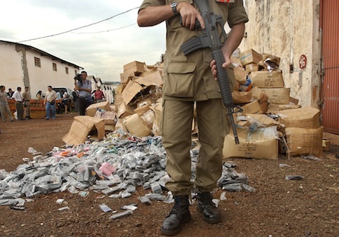 A Police officer guards fake merchandise valued at $5 million