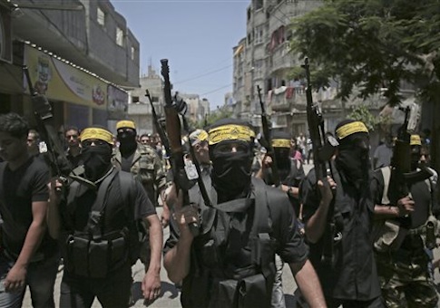 Masked militants march with guns