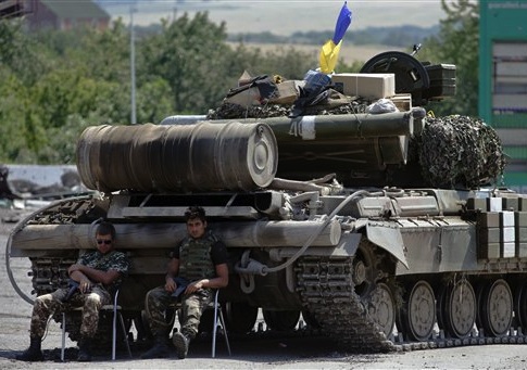 Ukrainian government army's soldiers rest near their tank at a check-point in the village of Debaltseve, Donetsk region