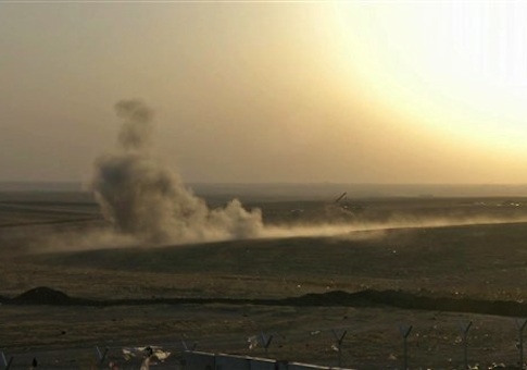 This image made from AP video shows smoke rising from airstrikes targeting Islamic State militants near the Khazer checkpoint outside of the city of Irbil in northern Iraq
