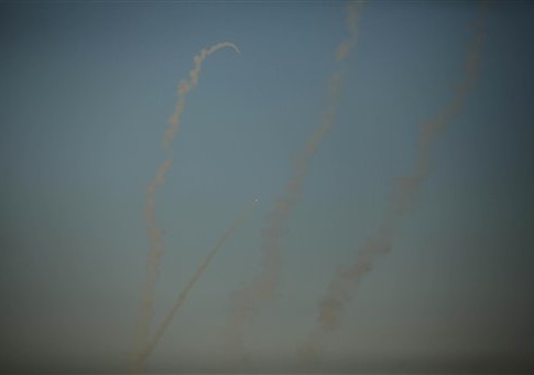 Smoke trails are seen as rockets are launched from the Gaza Strip towards Israel on August 20