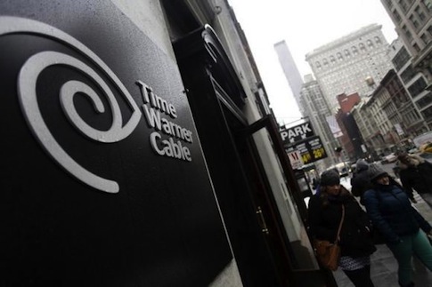 Pedestrians walk past the Time Warner Cable headquarters in New York February 13, 2014