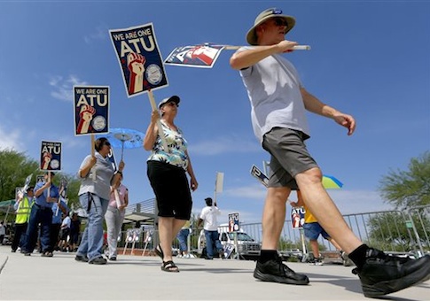 Members of the Amalgamated Transit Union Local 1433 strike in front of the First Transit Inc., bus depot on Thursday, Aug. 1, 2013