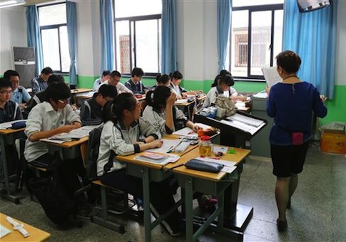 Chinese students listen to a teacher in the preparation for the annual National College Entrance Examination at a school in Shanghai, China