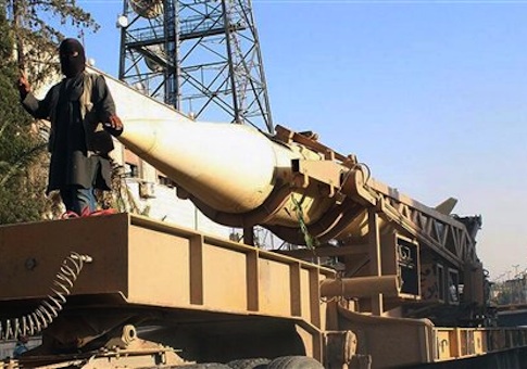 Fighters are shown from the al-Qaida linked Islamic State during a parade with a missile in Raqqa, Syria