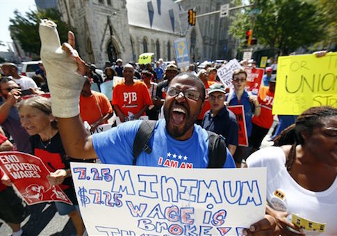 Protestors demonstrate to push fast-food chains to pay their employees at least $15 an hour, outside a McDonald's restaurant