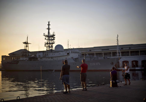 Men fish near the Russian warship Viktor Leonov CCB-175, docked in Havana's harbor, Cuba, Wednesday, Jan. 21, 2015