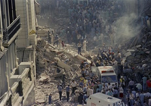 In this March 17, 1992 file photo, firemen and rescue workers walk through the debris of Israel's Embassy after a terrorist attack in Buenos Aires, Argentina