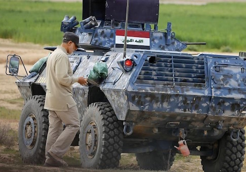 Iranian Revolutionary Guard Commander Qassem Soleimani walks near an armoured vehicle at the frontline during offensive operations against Islamic State militants in the town of Tal Ksaiba in Salahuddin province March 8