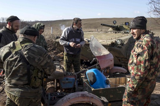Pro-Russian rebels talk on their position on a front line outside the village of Molochnoye, north-east from Donetsk, March 8