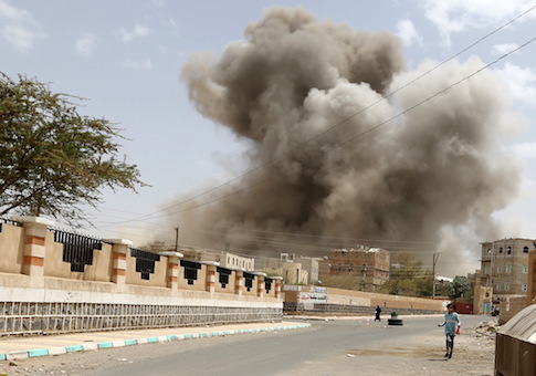 A girl runs for shelter during an air strike in Sanaa April 8