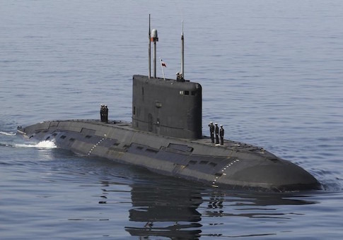 Iranian military personnel stand on a submarine during a naval parade on the last day of the Velayat-90 war game in the Sea of Oman near the Strait of Hormuz