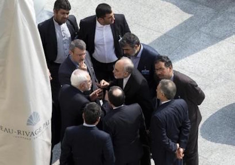 Iran's Foreign Minister Zarif and head of the Atomic Energy Organization of Iran Salehi talk outside with aides after a morning negotiation session with U.S. Secretary of State Kerry in Lausanne