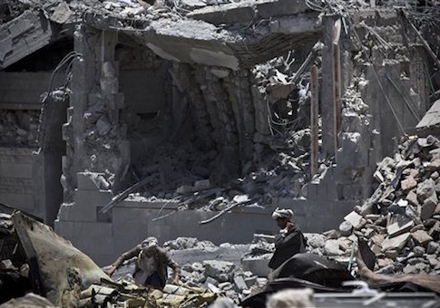 Shiite fighters, known as Houthis, collect ammunition at the residence of a military commander of the Houthi militant group, destroyed by a Saudi-led airstrike in Sanaa, Yemen, Tuesday, April 28
