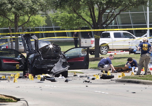Local police and FBI investigators collect evidence, including a rifle, where two gunmen were shot dead after their bodies were removed in Garland
