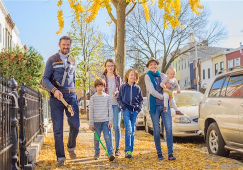 Family walking along street together