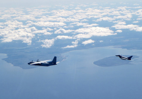 A Russian An26 Curl aircraft is shadowed by a RAF Typhoon (R) in this photograph handed out by the Royal Air force