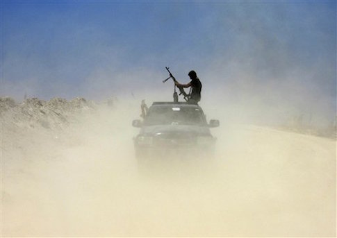 A fighter with Badr Brigades an armed Shiite group under the umbrella of the Popular Mobilization Forces loads his rifle as Iraqi security forces and allied Shiite Popular Mobilization Forces and Sunni tribal fighters, take combat positions outside Fallujah / AP