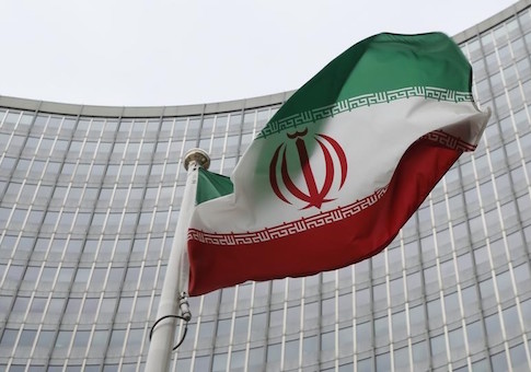 An Iranian flag flutters in front of the IAEA headquarters in Vienna