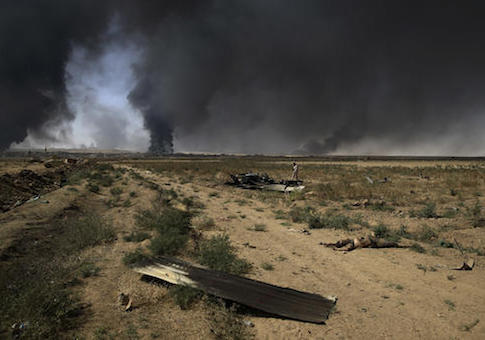 The body of an Islamic State militant lays on the ground after a repelled attack from the militants by the Iraqi army, outside the town of Qayyarah, Tuesday Oct. 4 / AP