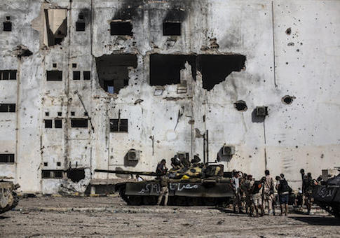 Fighters of the Libyan forces affiliated to the Tripoli government rest and reload weapons during combats against Islamic State militants