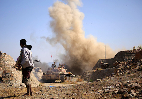 A Yemeni fighter loyal to Yemen's exiled President Abedrabbo Mansour Hadi, fires from a tank during clashes with Shiite Houthi rebels