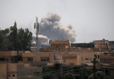 Smoke billows from the positions of the Islamic State militants after an airstrike in western Mosul, Iraq