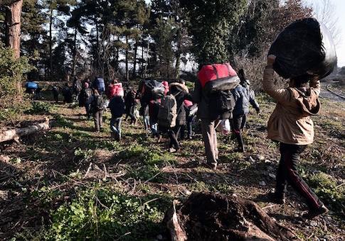 A group of Yazidis from Iraq carrying their arrive at a makeshift camp at the Greek-Macedonian border