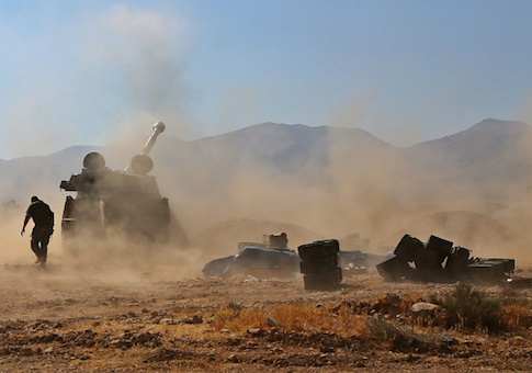 Syrian pro-government forces fire towards jihadist positions, in the western Qalamoun