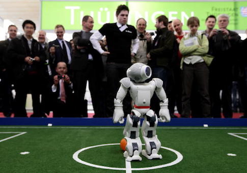 Robots play football in a demonstration of artificial intelligence