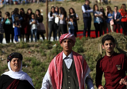 Iraqis Yazidis dance during a ceremony celebrating the Yazidi New Year north east of Mosul