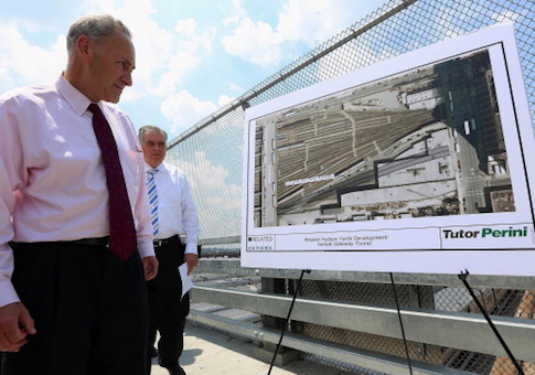 Sen. Chuck Schumer waits to speak at a news conference at the Hudson Yards site, part of the larger 'Gateway' Amtrak tunnel project