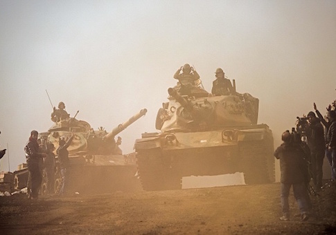 Turkish troops advance near the Syria border at Hassa, Hatay province