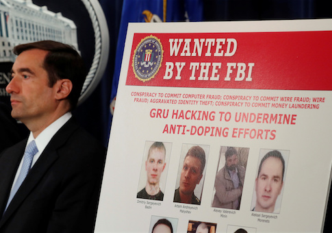 Demers listens during a cyber indictment press conference at the Department of Justice in Washington