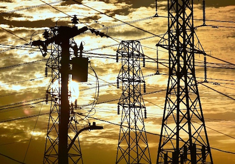 The sun sets behind power lines and poles in Rosemead, California, on July 9, 2018. - While temperatures have dropped slightly from the record heatwave which hit Southern California on July 6, thousands of people are still suffering from power outages resulting from the heatwave. (Photo by Frederic J. BROWN / AFP) (Photo credit should read FREDERIC J. BROWN/AFP/Getty Images)