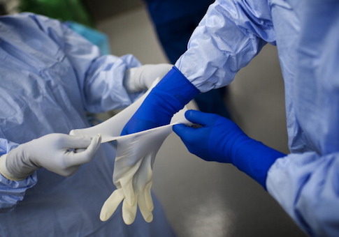 Nurses help Dr. Dorry Segev prepair for