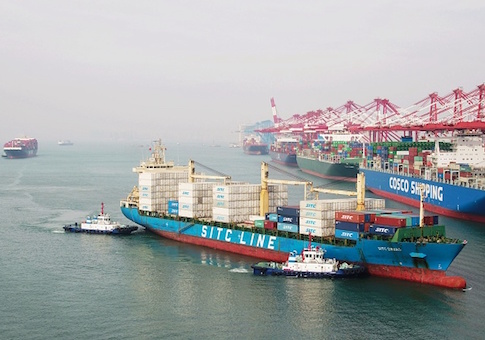 A cargo ship prepares to berth at a port in Qingdao in China's eastern Shandong province