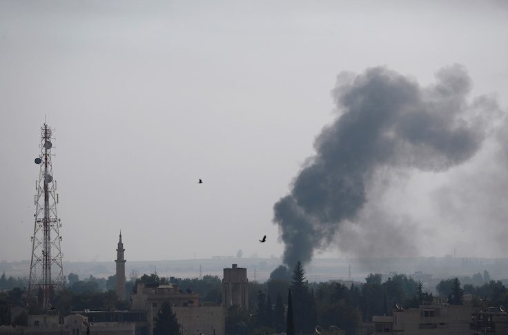 Smoke rises over the Syrian town of Ras al-Ain, as seen from the Turkish border town of Ceylanpinar, Sanliurfa province
