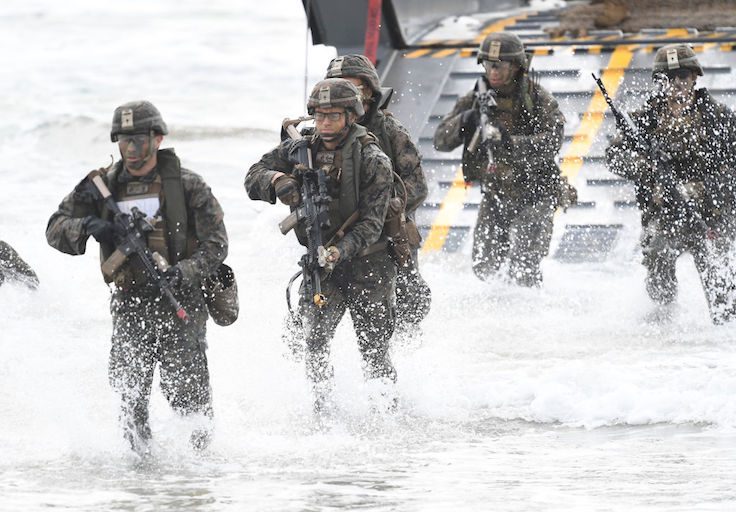 U.S Marines can be seen disembarking form a landing craft as part of an amphibious landing on July 22, 2019 in Bowen, Australia
