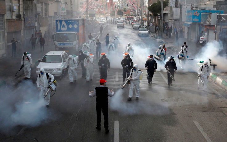 Iranian Firefighters disinfect streets in the capital Tehran in a bid to halt the wild spread of coronavirus