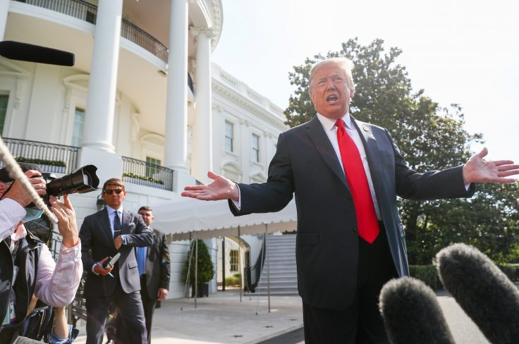 President Trump talks to reporters as he departs for a trip to Arizona at the White House in Washington