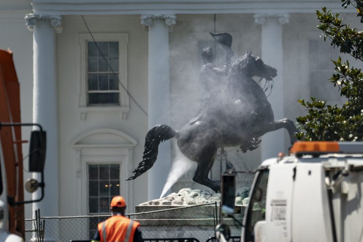 Workers clean the statue of Andrew Jackson in Lafayette Square