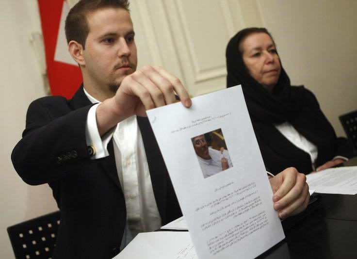 Daniel Levinson (L) shows a picture of his father, ex-FBI agent Robert Levinson during a press conference