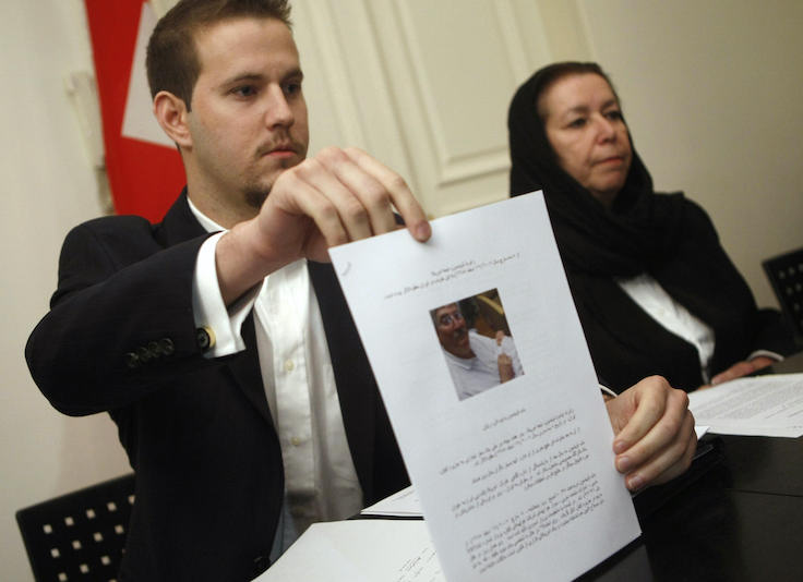 Daniel Levinson (L) shows a picture of his father, ex-FBI agent Robert Levinson during a press conference
